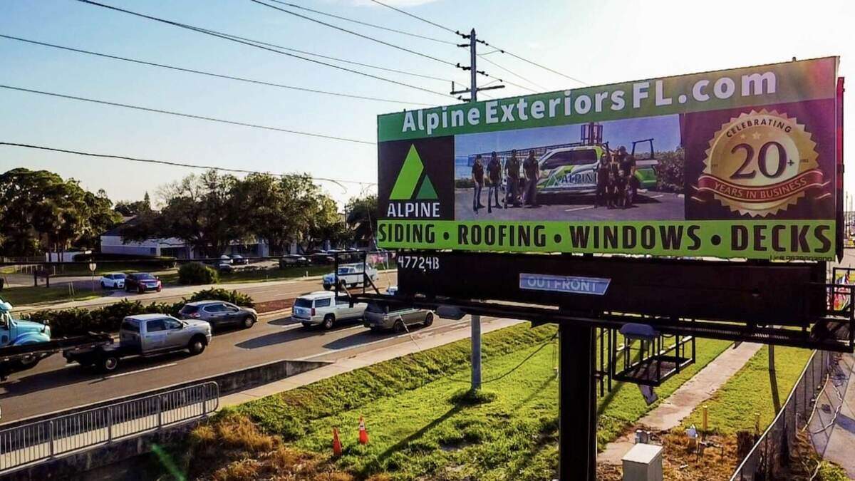 Alpine Exteriors Florida Billboard - Serving Sarasota Area with Premium Siding, Roofing, Windows & Decks featuring 20 years celebration and AlpineExteriorsFL.com